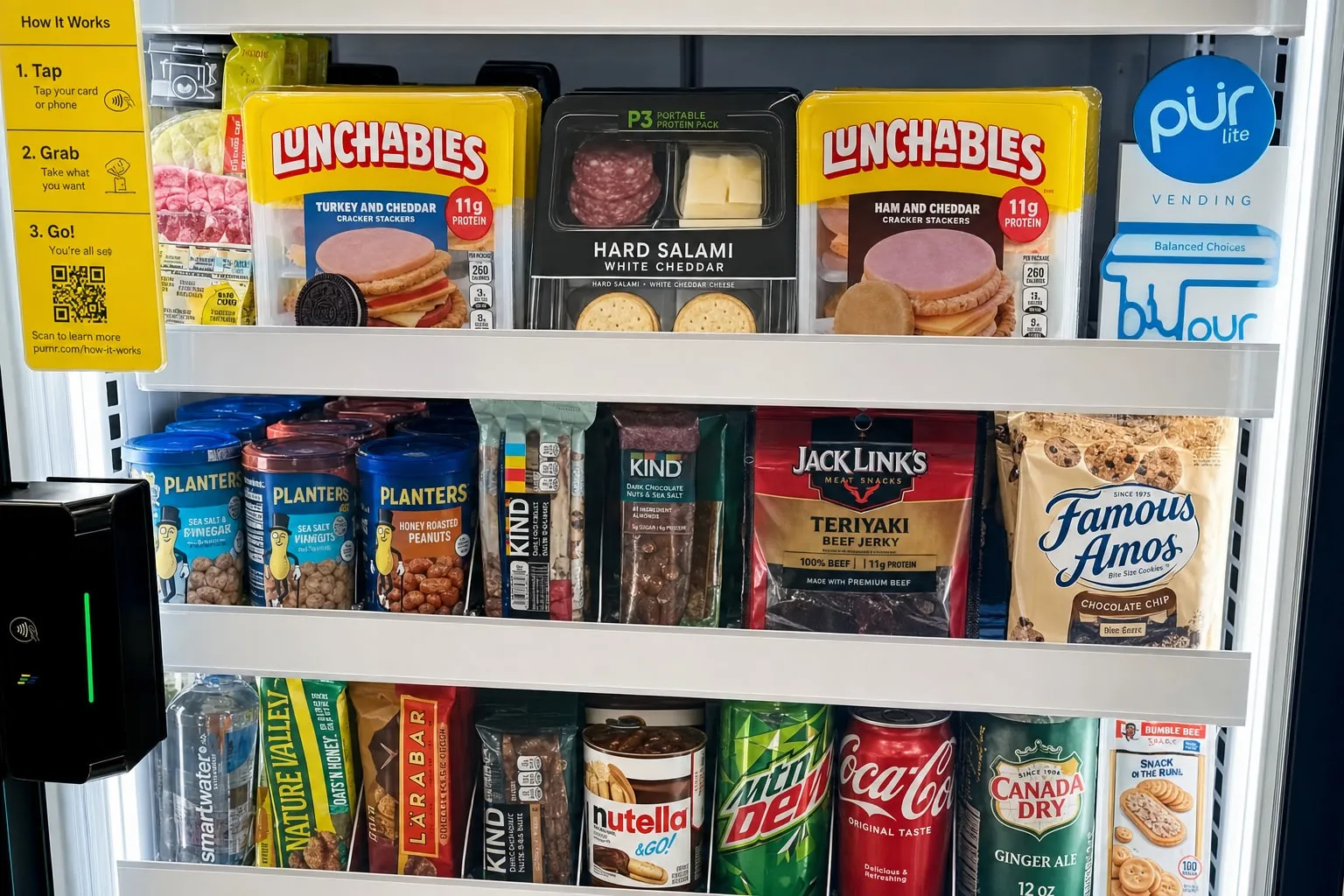 Smart cooler shelves stocked with fresh Lunchables meals, salami-and-cheese protein packs, Planters nuts, KIND bars, jerky and cookies