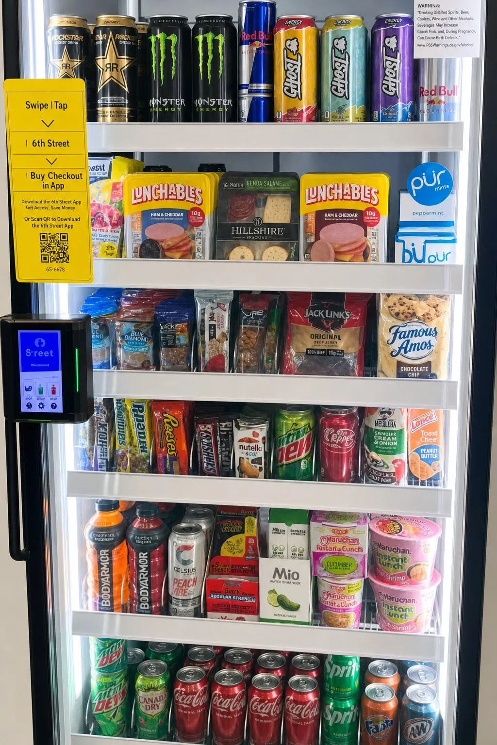 Glass-door smart cooler fully stocked with cold drinks, fresh food and grab-and-go snacks at a Southern California workplace